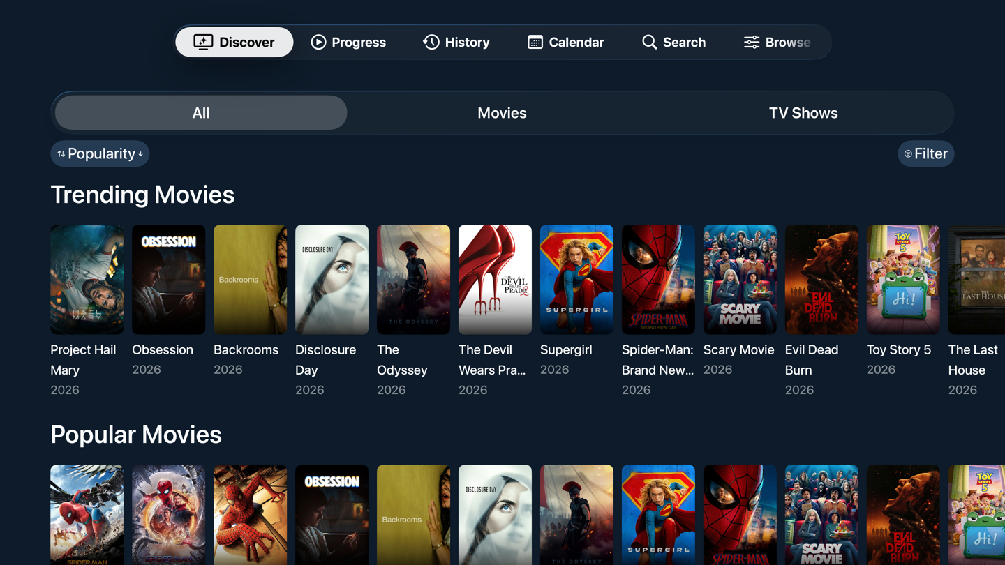 The Discover screen on Apple TV, with trending films in a wide poster row beneath the top bar navigation.